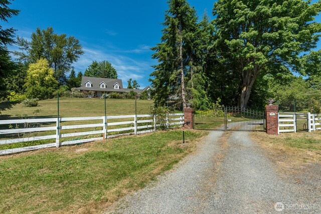 909 308th St NE, Stanwood, WA 98282 - view of dirt / gravel driveway featuring a gate and a gated entry