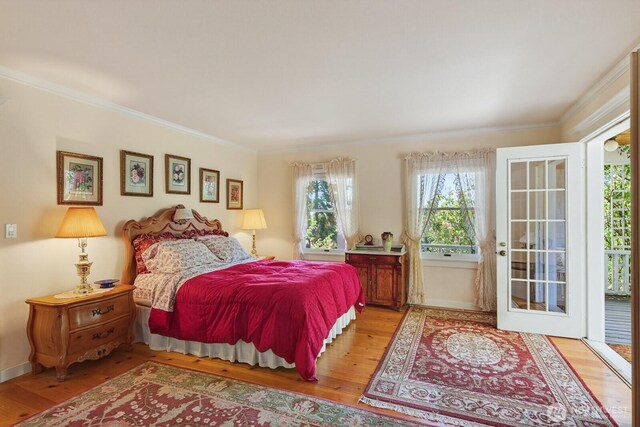 909 308th St NE, Stanwood, WA 98282 - bedroom with wood finished floors, ornamental molding, and access to outside