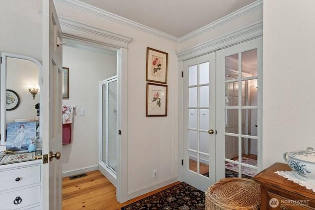 909 308th St NE, Stanwood, WA 98282 - doorway to outside featuring french doors, light wood-type flooring, and crown molding
