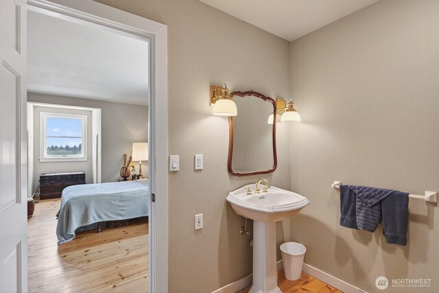 909 308th St NE, Stanwood, WA 98282 - bathroom featuring wood finished floors and connected bathroom