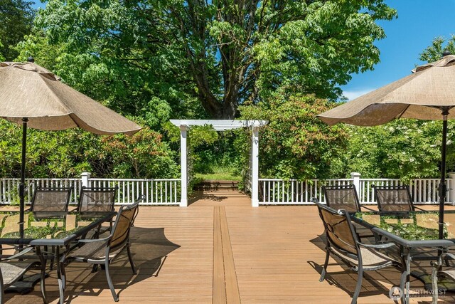 909 308th St NE, Stanwood, WA 98282 - wooden deck featuring outdoor dining space and view of scattered trees