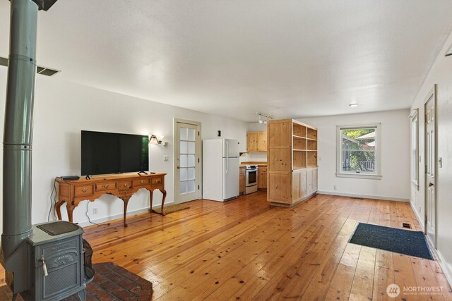 909 308th St NE, Stanwood, WA 98282 - living room featuring a wood stove and light wood-style floors