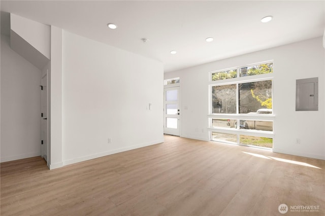 6544D Latona Ave NE, Seattle, WA 98115 - unfurnished living room with electric panel, light wood-style flooring, and recessed lighting
