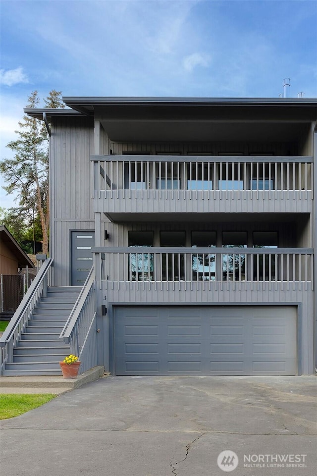 3 Burning Tree Dr Unit 3, Yakima, WA 98902 - view of front facade with a balcony, stairs, driveway, and a garage