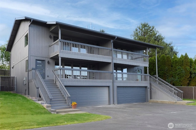 3 Burning Tree Dr Unit 3, Yakima, WA 98902 - view of property with a balcony, stairway, an attached garage, and asphalt driveway