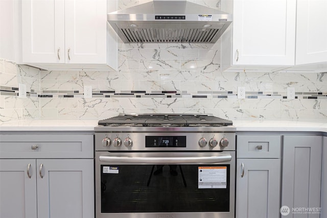 3 Burning Tree Dr Unit 3, Yakima, WA 98902 - kitchen with stainless steel range with gas stovetop, wall chimney exhaust hood, tasteful backsplash, and white cabinetry