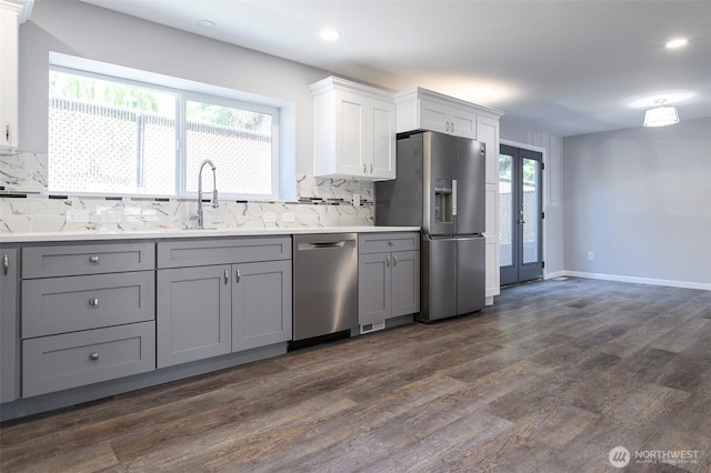 3 Burning Tree Dr Unit 3, Yakima, WA 98902 - kitchen featuring stainless steel appliances, gray cabinets, decorative backsplash, dark wood-type flooring, and light countertops