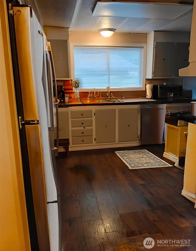 16120 Jordan Way, Arlington, WA 98223 - kitchen featuring stainless steel appliances, dark wood-type flooring, range hood, and dark countertops