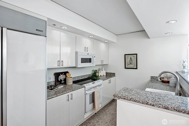 2000 1st Ave Unit 703, Seattle, WA 98121 - kitchen with white appliances, recessed lighting, white cabinetry, and stone countertops