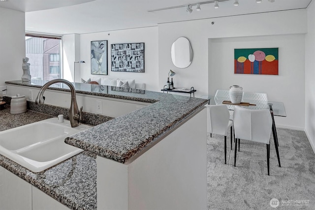 2000 1st Ave Unit 703, Seattle, WA 98121 - kitchen with a sink and dark stone countertops