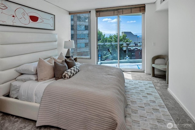 2000 1st Ave Unit 703, Seattle, WA 98121 - carpeted bedroom with access to exterior and baseboards