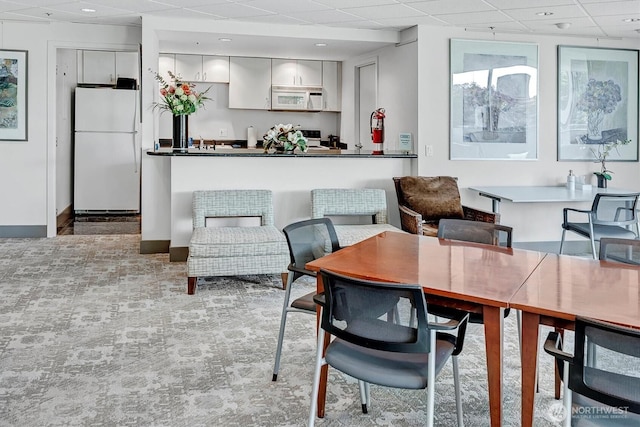 2000 1st Ave Unit 703, Seattle, WA 98121 - dining room featuring a paneled ceiling and light carpet