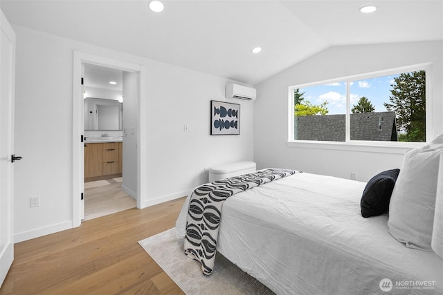 3424 20th Ave S, Seattle, WA 98144 - bedroom with an AC wall unit, recessed lighting, light wood-style floors, vaulted ceiling, and connected bathroom
