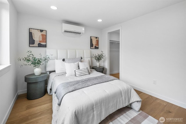 3424 20th Ave S, Seattle, WA 98144 - bedroom with a wall mounted air conditioner, recessed lighting, wood finished floors, and a spacious closet