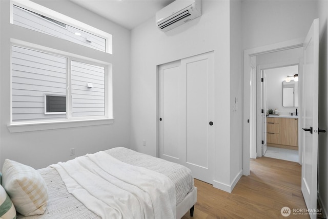 3424 20th Ave S, Seattle, WA 98144 - bedroom with a wall unit AC, light wood-style flooring, and a closet