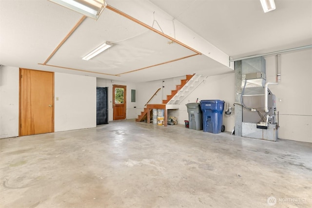 16740 Dunbar Rd, Mount Vernon, WA 98273 - garage featuring electric panel, freestanding refrigerator, and heating unit