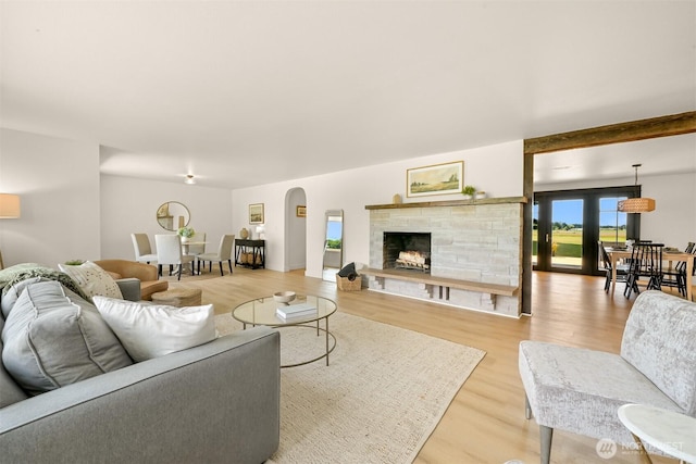 16740 Dunbar Rd, Mount Vernon, WA 98273 - living area featuring light wood-type flooring, a fireplace, and arched walkways