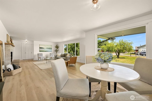 16740 Dunbar Rd, Mount Vernon, WA 98273 - dining space with light wood-style flooring and a fireplace with raised hearth