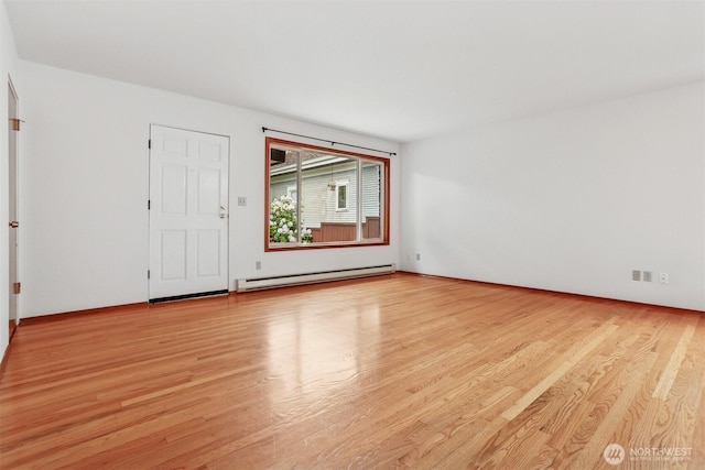 1919 2nd Ave W, Seattle, WA 98119 - empty room featuring a baseboard heating unit and light wood-style flooring