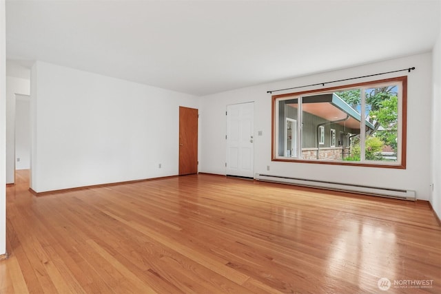 1919 2nd Ave W, Seattle, WA 98119 - unfurnished room featuring baseboard heating and light wood finished floors