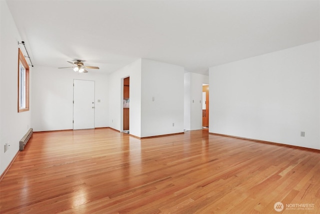 1919 2nd Ave W, Seattle, WA 98119 - unfurnished living room with a baseboard heating unit, ceiling fan, and light wood finished floors