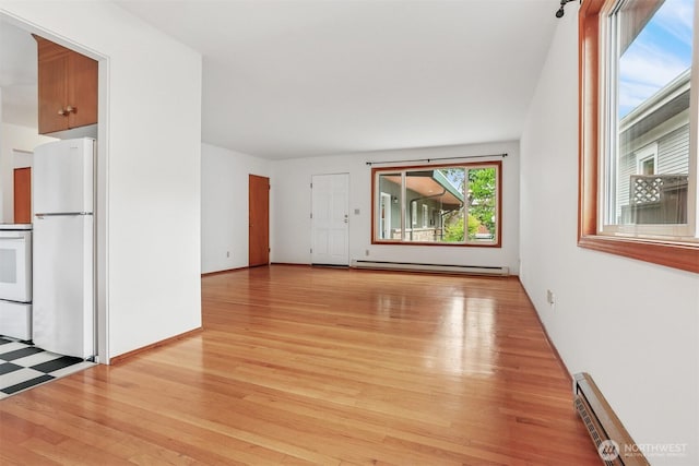 1919 2nd Ave W, Seattle, WA 98119 - unfurnished living room with a baseboard radiator, light wood finished floors, and baseboard heating