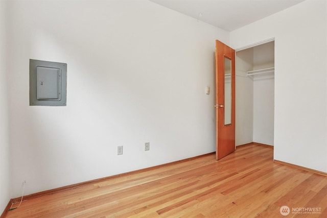 1919 2nd Ave W, Seattle, WA 98119 - unfurnished bedroom with electric panel, light wood-style flooring, and a closet