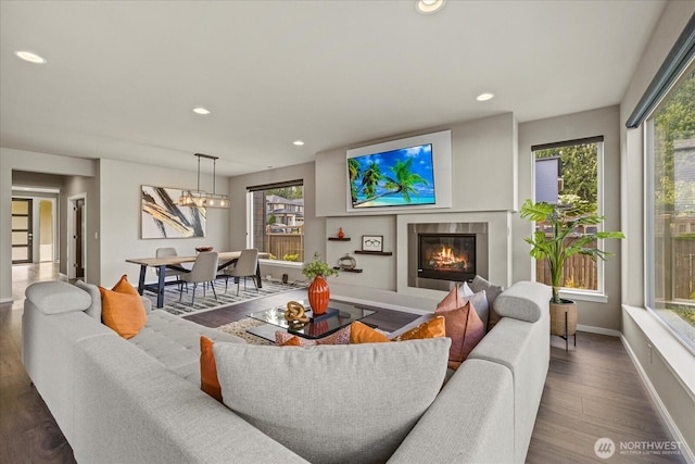 35404 55th Ave S, Auburn, WA 98001 - living room featuring healthy amount of natural light, a glass covered fireplace, recessed lighting, a chandelier, and wood finished floors