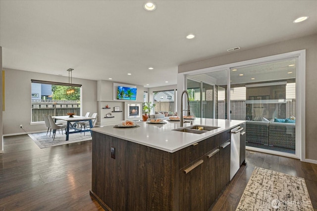35404 55th Ave S, Auburn, WA 98001 - kitchen featuring dark brown cabinetry, open floor plan, light countertops, a kitchen island with sink, and recessed lighting