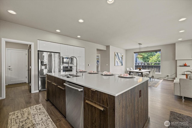 35404 55th Ave S, Auburn, WA 98001 - kitchen with appliances with stainless steel finishes, dark brown cabinetry, light countertops, a center island with sink, and recessed lighting