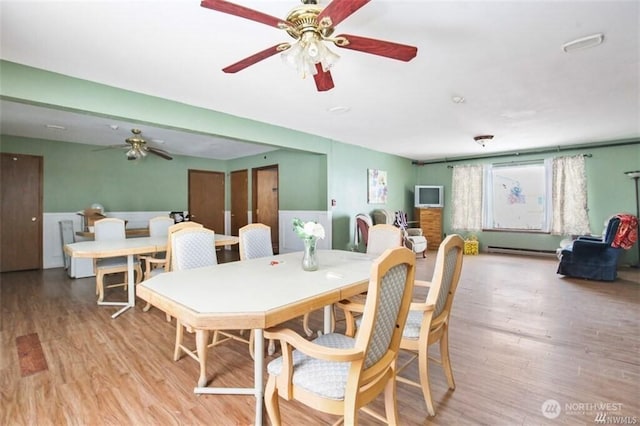 715 Locust St, Omak, WA 98841 - dining area featuring a ceiling fan, wood finished floors, and baseboard heating