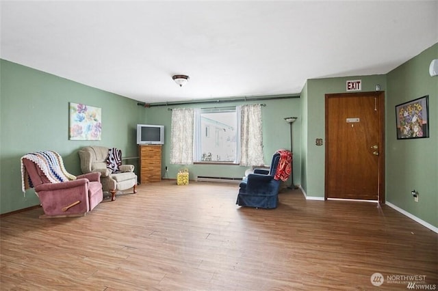 715 Locust St, Omak, WA 98841 - living area featuring wood finished floors and baseboard heating