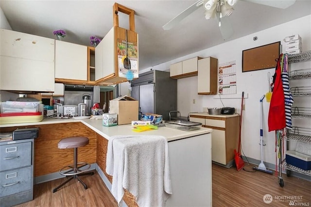 715 Locust St, Omak, WA 98841 - kitchen featuring light wood-type flooring, a peninsula, a ceiling fan, and high quality fridge