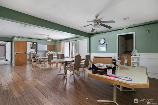 715 Locust St, Omak, WA 98841 - dining room featuring a ceiling fan, wood finished floors, and a wainscoted wall