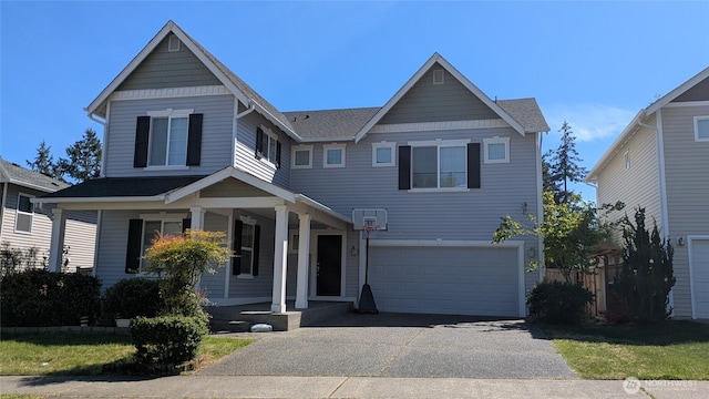 1077 Hiton Cir, Dupont, WA 98327 - view of front of property featuring a garage, covered porch, and driveway