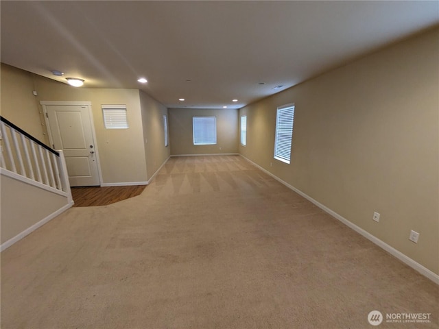 1077 Hiton Cir, Dupont, WA 98327 - basement featuring light colored carpet, stairs, and recessed lighting