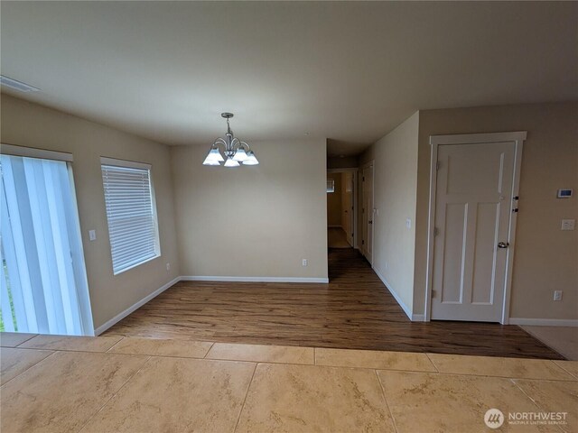 1077 Hiton Cir, Dupont, WA 98327 - unfurnished dining area with a chandelier and tile patterned flooring