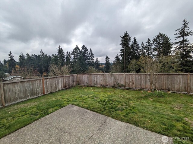 1077 Hiton Cir, Dupont, WA 98327 - fenced backyard featuring a patio area