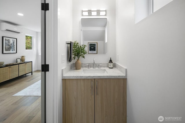3422 20th Ave S, Seattle, WA 98144 - bathroom featuring a wall mounted air conditioner, vanity, wood finished floors, and recessed lighting
