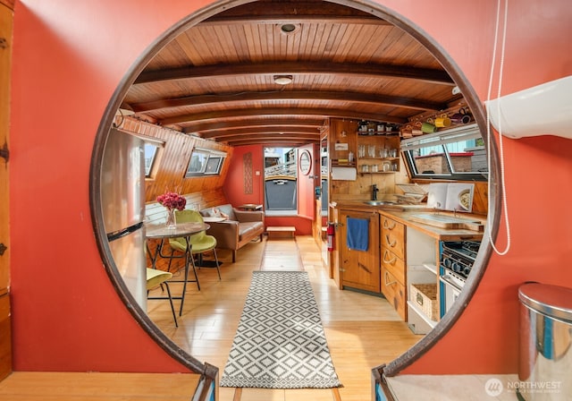 2550-2738 Westlake Ave N Unit 01-117, Seattle, WA 98109 - kitchen with light wood finished floors, wooden ceiling, arched walkways, and stainless steel gas range oven