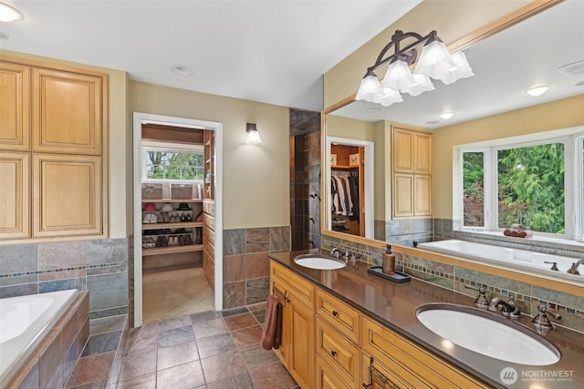 16908 SE Licorice Way, Newcastle, WA 98059 - full bath featuring healthy amount of natural light, a bath, double vanity, tile walls, and a wainscoted wall