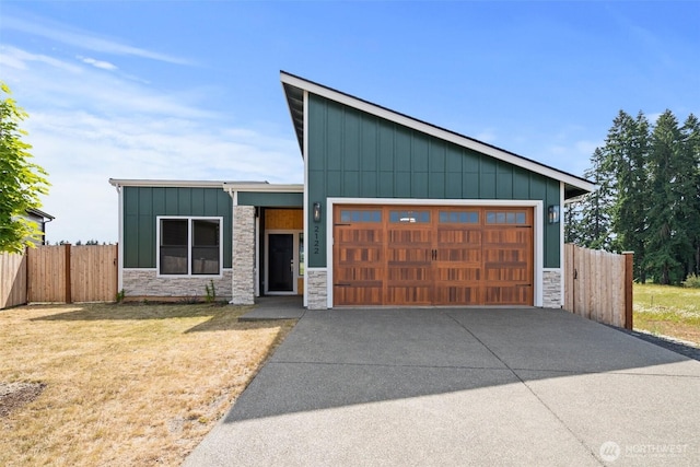 2122 Hawks View Ln, Winlock, WA 98596 - view of front of home with stone siding, board and batten siding, a garage, and concrete driveway