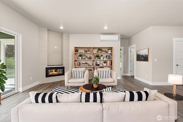 2122 Hawks View Ln, Winlock, WA 98596 - living room with a wall mounted AC, wood finished floors, a fireplace, and recessed lighting