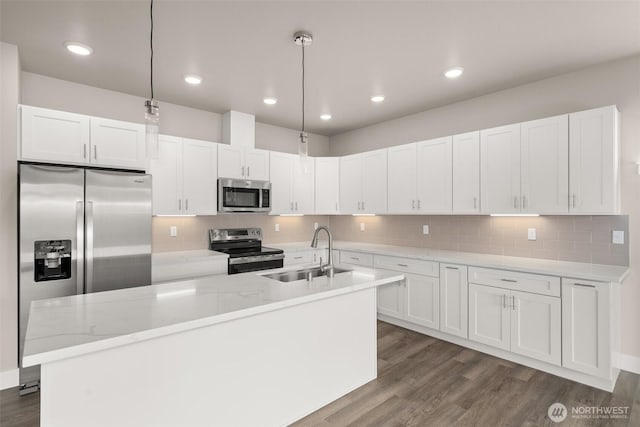 2122 Hawks View Ln, Winlock, WA 98596 - kitchen with stainless steel appliances, white cabinetry, dark wood finished floors, a kitchen island with sink, and tasteful backsplash