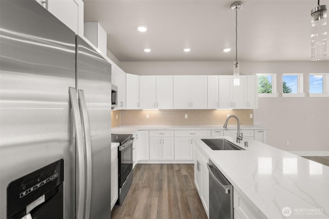 2122 Hawks View Ln, Winlock, WA 98596 - kitchen featuring stainless steel appliances, light stone counters, white cabinetry, tasteful backsplash, and recessed lighting
