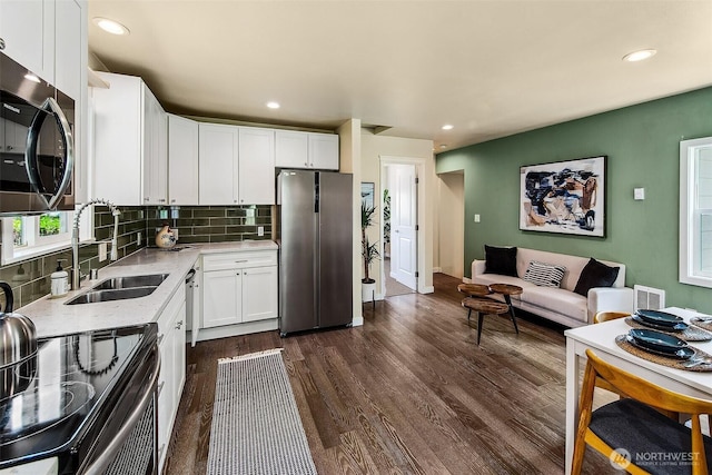 8430 34th Ave S, Seattle, WA 98118 - kitchen featuring stainless steel appliances, tasteful backsplash, white cabinets, dark wood-style flooring, and recessed lighting