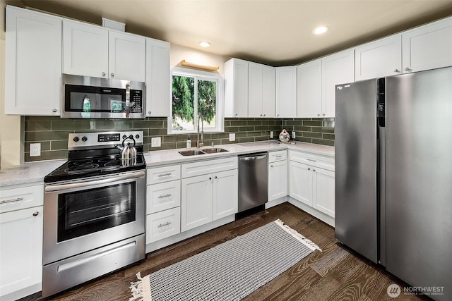 8430 34th Ave S, Seattle, WA 98118 - kitchen with stainless steel appliances, white cabinets, tasteful backsplash, dark wood-style flooring, and recessed lighting