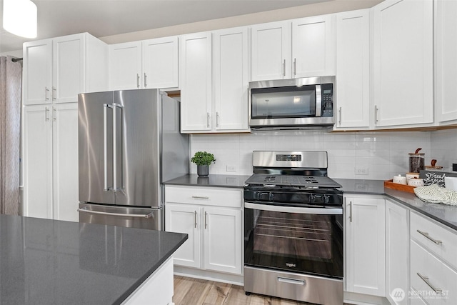 8705 126th Street Ct E, Puyallup, WA 98374 - kitchen with stainless steel appliances, white cabinetry, and decorative backsplash