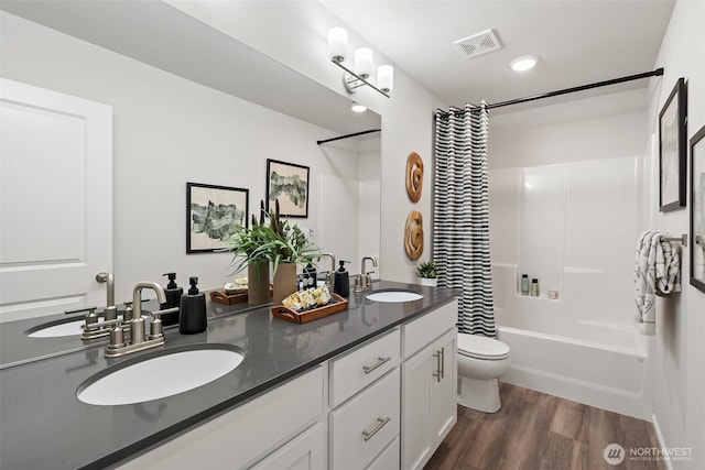8705 126th Street Ct E, Puyallup, WA 98374 - full bath featuring double vanity, shower / tub combo, and wood finished floors