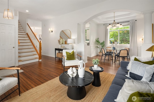 23618 Carter Rd, Bothell, WA 98021 - living area featuring ornate columns, arched walkways, wood finished floors, stairs, and recessed lighting